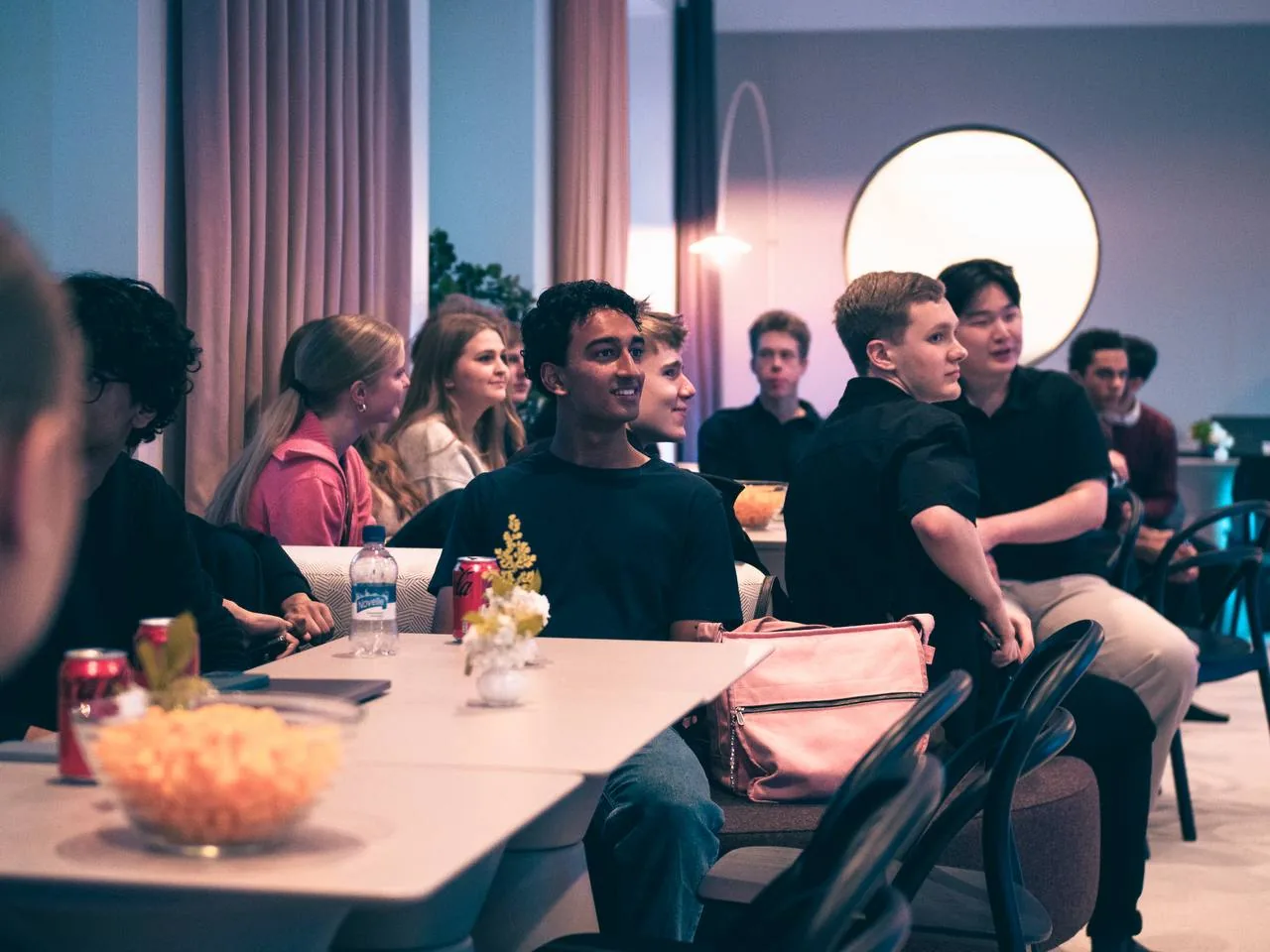 STUHI members gathered around a table at a community evening